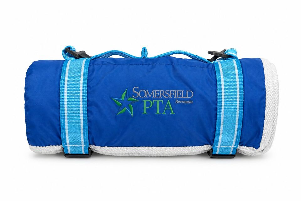 Blue Somersfield PTA picnic blanket, rolled with carry strap